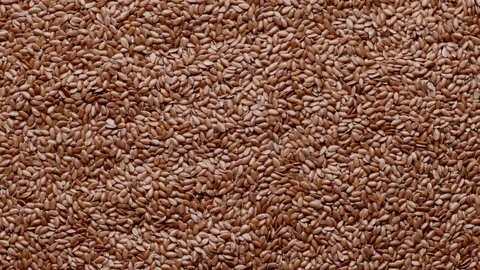 Group of raw flaxseeds rotating in а circle Stock Footage 119848345