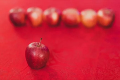 Group of red apples on table cloth of the same color Stock Photos