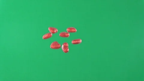 Group of red heart-shaped objects being thrown in the air on green screen Stock Footage 100617911