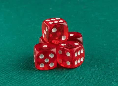 Group of red playing dice on a green background, isolated Stock Photos