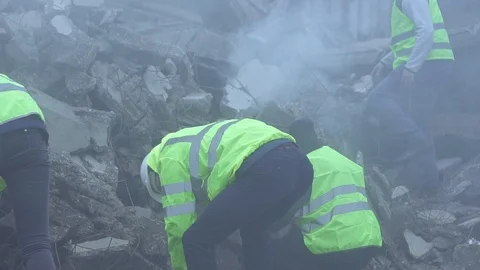 A group of rescue workers dismantle the rubble of the destroyed house after the Stock Footage 98035478