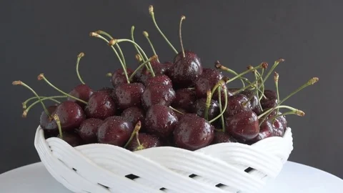 A Group of Ripe Dark Red Cherries in a Beautiful White Plate. Stock-Footage 77094283