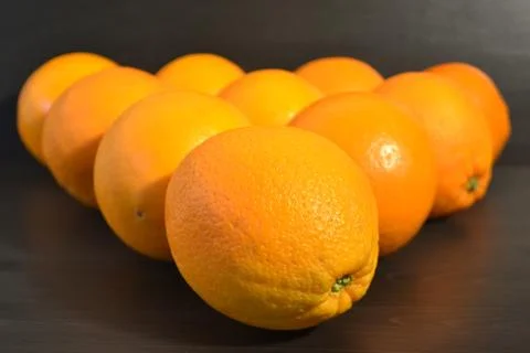 Group of ripe oranges in a shape of a triangle. Stock Photos