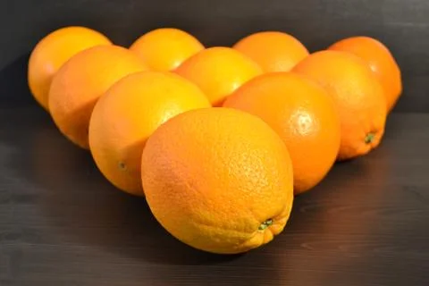 Group of ripe oranges in a shape of a triangle. Stock Photos