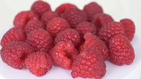 Group of ripe raspberries presented in minimal style composition. Perfect for Video stock 332875703