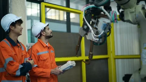 A group of Robotics engineers working with Programming and Manipulating Rob.. Stock Footage 280789135