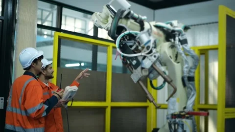 A group of Robotics engineers working with Programming and Manipulating Rob.. Stock Footage 280789182