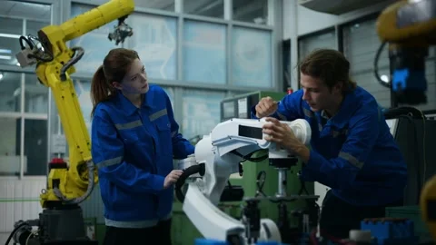 A group of Robotics engineers working with Programming and Manipulating Rob.. Stock Footage 280791375