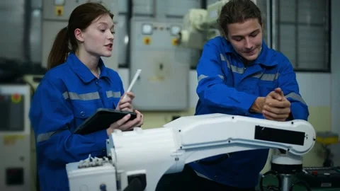 A group of Robotics engineers working with Programming and Manipulating Rob.. Stock Footage 280791389