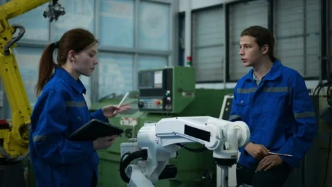 A group of Robotics engineers working with Programming and Manipulating Rob.. Stock Footage 280791401