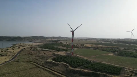A group of rotating wind turbine generators Stock Footage 244047385