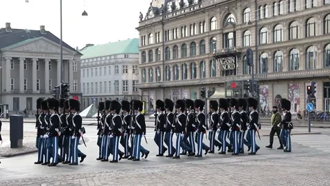 A group of royal guards pass through Kongens Nytorv Square during a parade Stock Footage 147691524