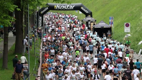 Group of runners running up and down the hill on a city run, Bern Grand Prix Stock Footage 275887702