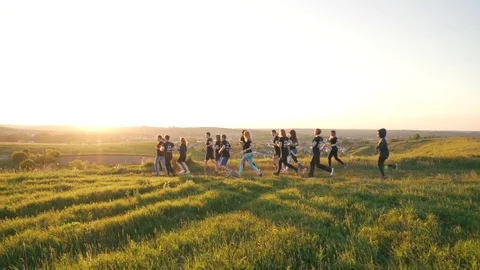 Group running outdoors in the sunlight Stock Footage 94669838