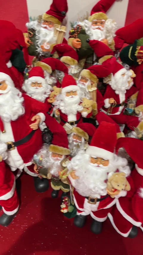 Group of Santa Claus figures, of different sizes in a Christmas decoration store Stock Footage 220749573