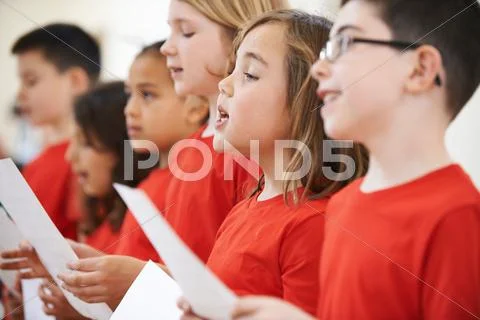 Group Of School Children Singing In Choir Together Stock Photos
