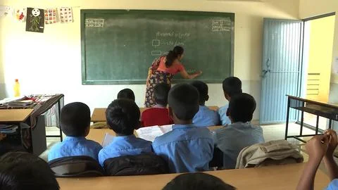 A group of school children studing in a class in a local village school Foto stock