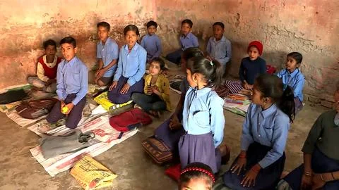 A group of school children studing in a class in a local village school Stock Photos
