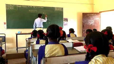 A group of school children studing in a class in a local village school Stock Photos
