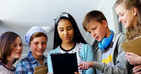 Group of school friends using digital tablet in corridor Stock Footage 74578076