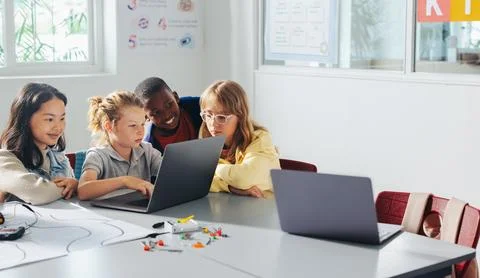 Group of school kids learn to code and program robots in a computer-based cla Stock Photos