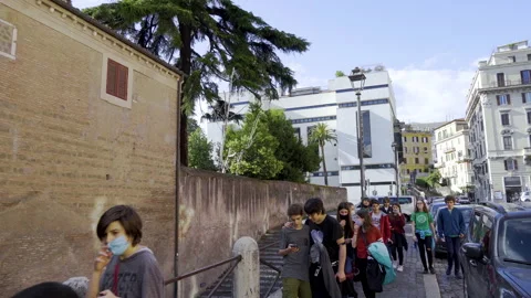 Group of schoolchildren pass in front of the Basilica di San Clemente Stock Footage 133077679
