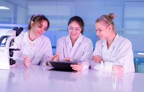 Group of science students working together in a laboratory with a tablet wh.. Stock Photos