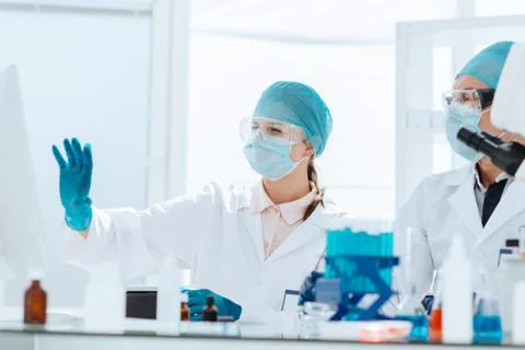 Group of scientists discussing online data in the laboratory. Stock Photos