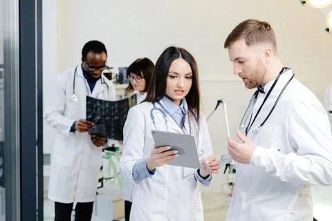 Group of scientists examining data on paper Stock Photos