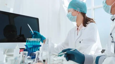 Group of scientists looking at a computer screen in the laboratory. Stock Photos