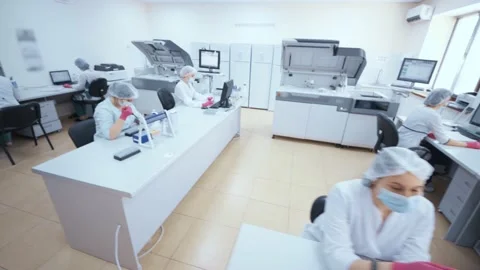 Group of scientists from a modern clinic or laboratory are examining test Stock-Footage 190089726