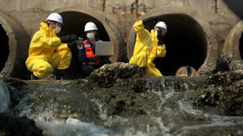 Group of scientists in protective suits are collecting water samples Video stock 340077975