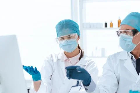 Group of scientists using a computer to classify data. 스톡 사진