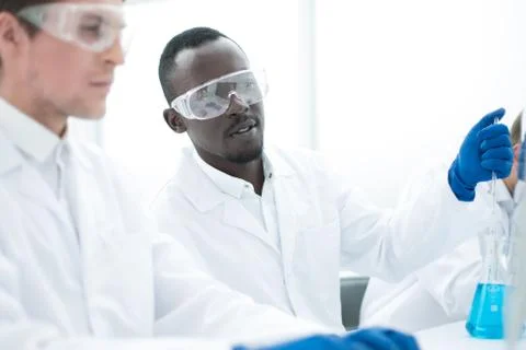 Group of scientists using a computer to enter data Stock Photos