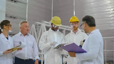 Group of scientists in white robes visit modern energy research laboratory of Stock Footage 120744885