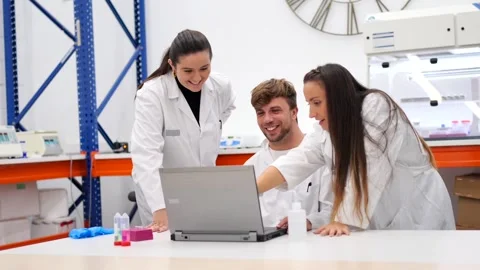 Group of scientists working together on laptop Video stock 255196201