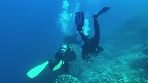 Group of Scuba Divers Exploring Deep Underwater World in 4K Stock Footage 324509914