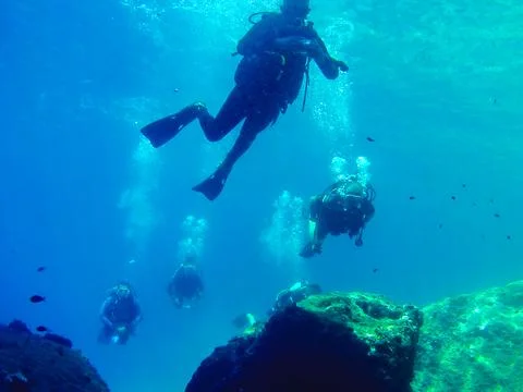 Group of Scuba Divers Exploring Underwater in Loutraki, Greece. Stock Photos
