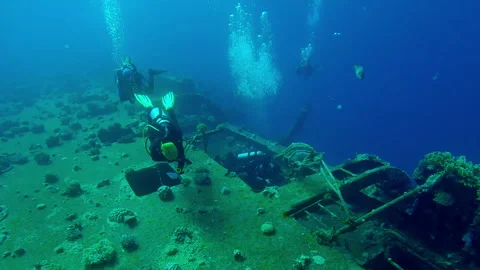 Group of scuba divers swims along board and corridors on wreck of Salem Express Stock Footage 331583647