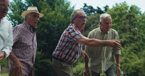 Group of Senior Men Playing Petanque in a Park Stock Footage 231675760