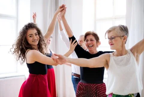 Group of senior people in dancing class with dance teacher. Stock Photos