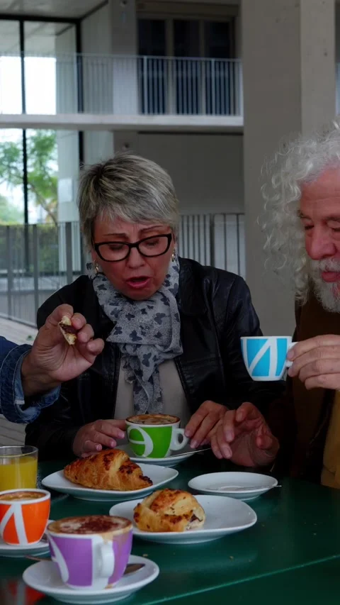 Group of senior people sitting at table enjoying breakfast in the morning Stock Footage 281153002