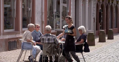 Group of seniors people having a drink in the old town of Miltenberg, Germany Stock Footage 113404953