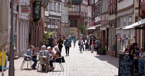 Group of seniors people having a drink in the old town of Miltenberg, Germany Stock Footage 113405053