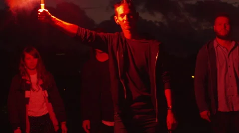 Group of Serious Teenagers with one Holding and Waving Red Signal Flare Stock Footage