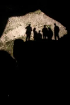 Group shadows cast on to cave floor 스톡 사진