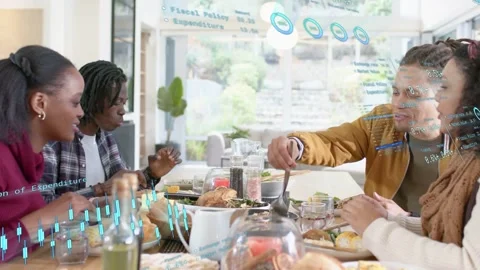 Group sharing meal, leading to man scooping food while data charts projecting Stock Footage 333485674