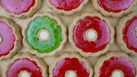 Group of shortcake with red jam and one with green rotate on wood background Stock Footage 169871521