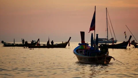 Group of silhouette long tail boat converted to boat excursions floating in t Stock Footage 83473953