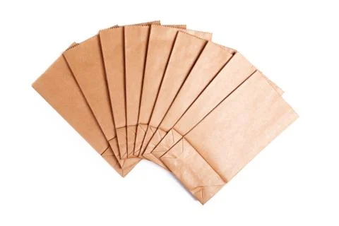 Group of simple blank brown small paper bags set spread out Foto stock